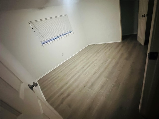 unfurnished bedroom with baseboards and wood finished floors