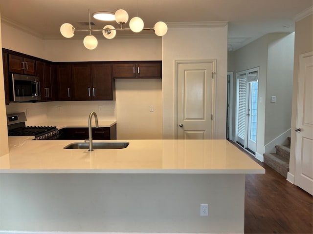 4327 Robertson St, Houston, TX 77009 - kitchen with a sink, appliances with stainless steel finishes, dark brown cabinetry, and ornamental molding