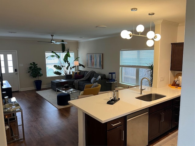 4327 Robertson St, Houston, TX 77009 - kitchen with stainless steel dishwasher, dark brown cabinets, a sink, and light countertops