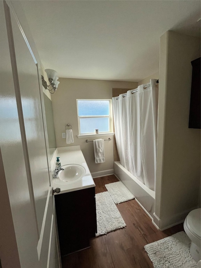 4327 Robertson St, Houston, TX 77009 - bathroom featuring vanity, shower / bathtub combination with curtain, toilet, and wood finished floors