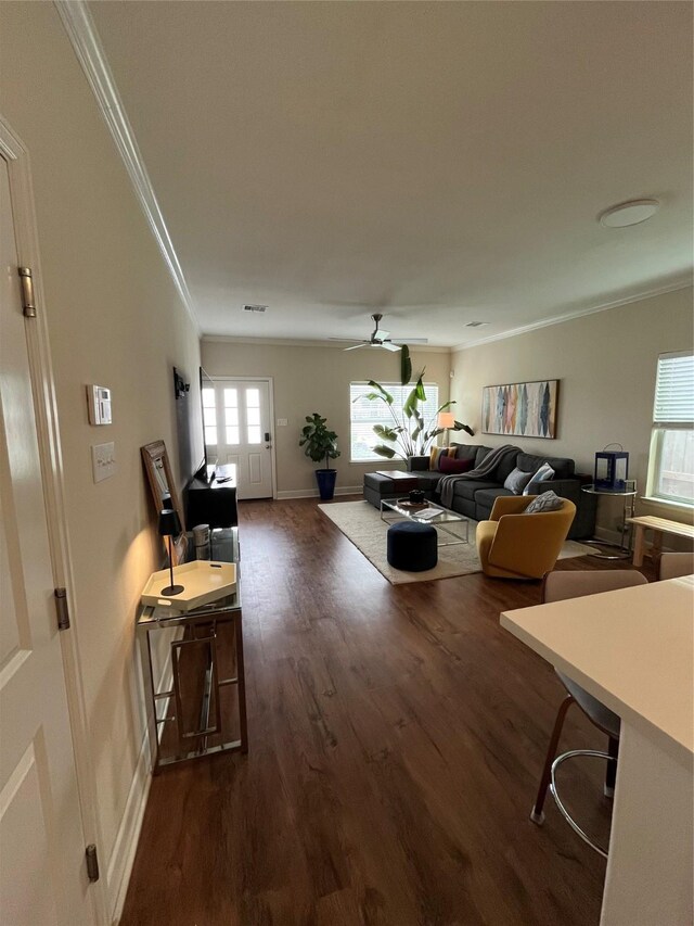 4327 Robertson St, Houston, TX 77009 - living room with baseboards, ornamental molding, dark wood-style flooring, and ceiling fan