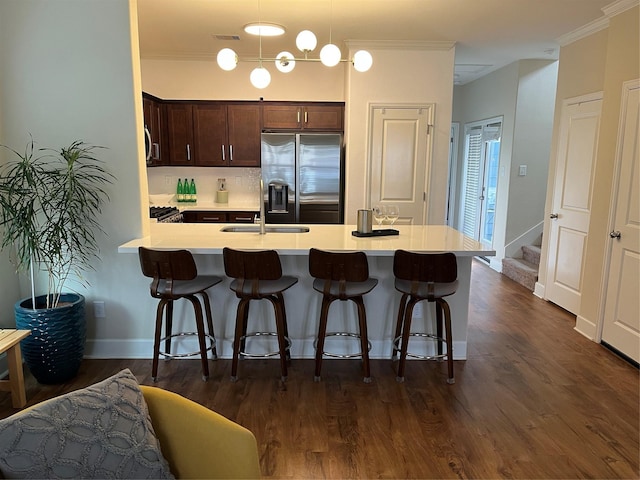 4327 Robertson St, Houston, TX 77009 - kitchen with a sink, stainless steel fridge with ice dispenser, light countertops, a peninsula, and a kitchen bar