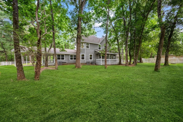 view of yard with a sunroom and fence