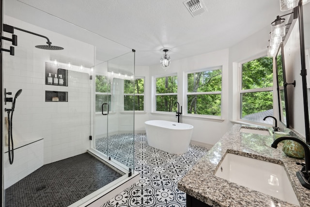 full bathroom with plenty of natural light, a sink, and a stall shower
