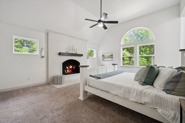 bedroom with a brick fireplace, lofted ceiling, baseboards, ceiling fan, and carpet