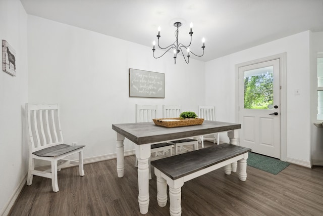 dining area with baseboards, dark wood finished floors, and an inviting chandelier
