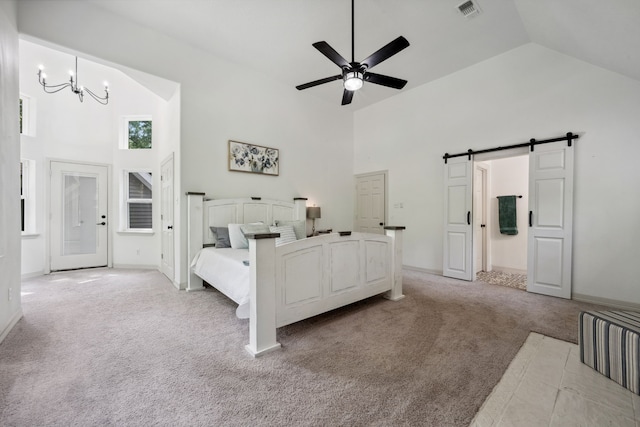 bedroom with visible vents, light colored carpet, a barn door, high vaulted ceiling, and baseboards