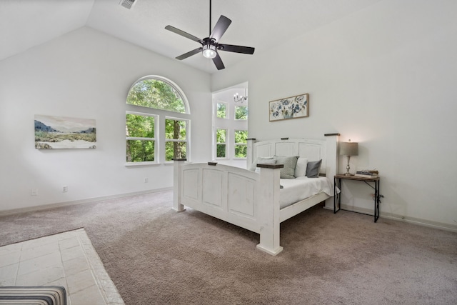 carpeted bedroom featuring baseboards, ceiling fan with notable chandelier, and high vaulted ceiling