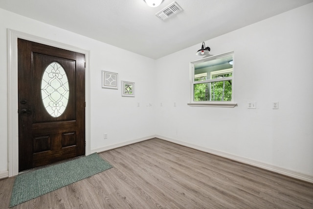 entrance foyer featuring visible vents, baseboards, and wood finished floors
