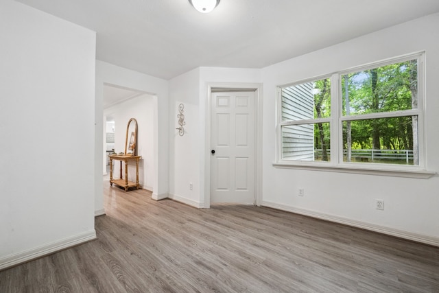 empty room featuring baseboards and wood finished floors