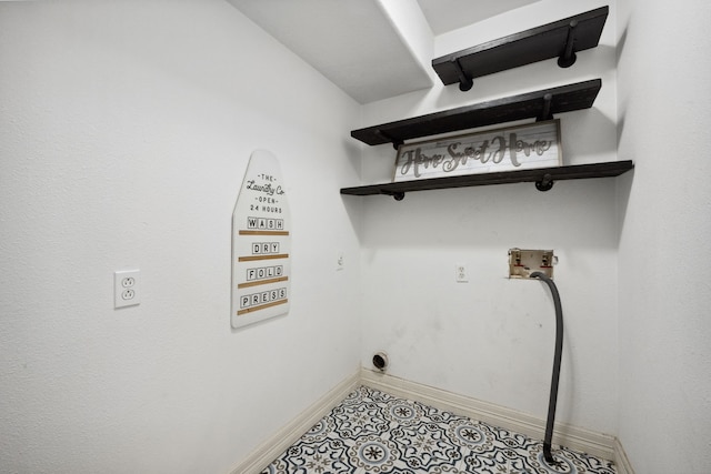 clothes washing area with laundry area, baseboards, washer hookup, light tile patterned floors, and hookup for an electric dryer
