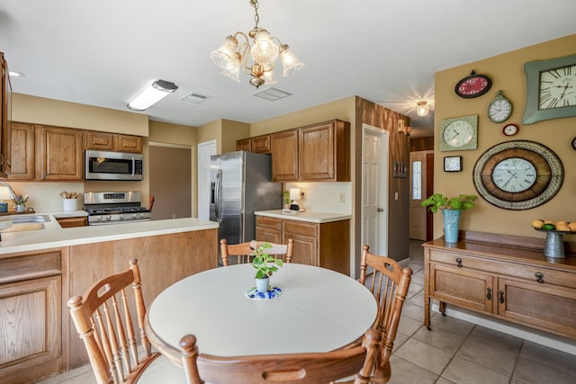 11203 Rocky Mill Dr, Cypress, TX 77429 - kitchen with a notable chandelier, appliances with stainless steel finishes, a sink, light tile patterned floors, and visible vents