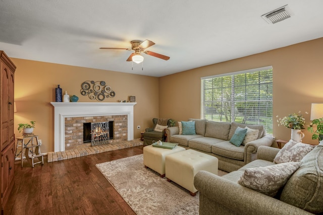 11203 Rocky Mill Dr, Cypress, TX 77429 - living room with dark wood-style flooring, a ceiling fan, visible vents, and a fireplace