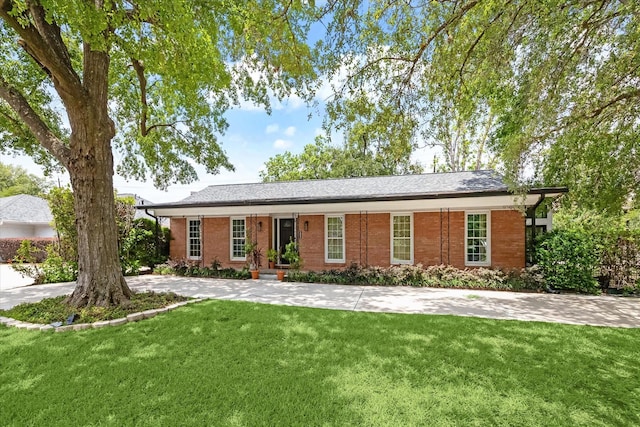 single story home with a front lawn and brick siding