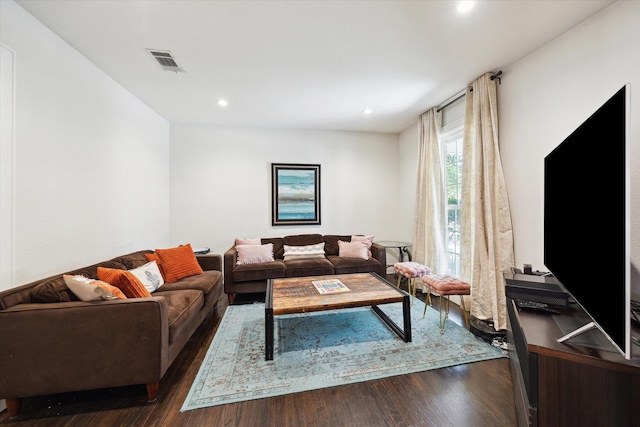 living area featuring recessed lighting, dark wood-style flooring, and visible vents