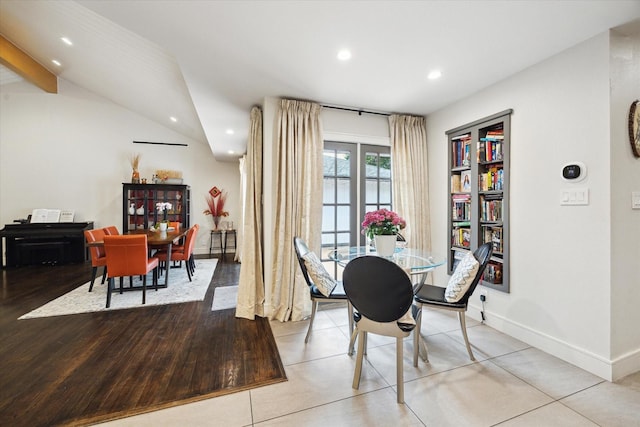 dining room with recessed lighting, lofted ceiling with beams, baseboards, and light wood-type flooring