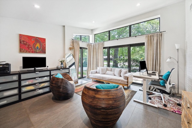 living area with recessed lighting and a towering ceiling