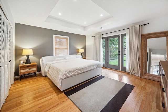 1902 Chimney Rock Rd, Houston, TX 77056 - bedroom with access to exterior, light wood-style flooring, recessed lighting, a tray ceiling, and visible vents
