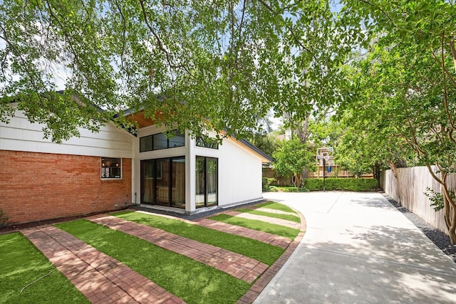 view of yard featuring a patio and fence