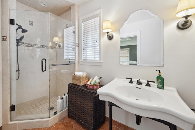 full bath with a shower stall and tile patterned flooring