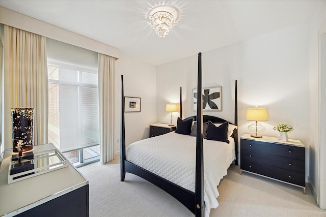 2207 Bancroft St Unit 301, Houston, TX 77027 - bedroom featuring light carpet, multiple windows, access to outside, and a chandelier