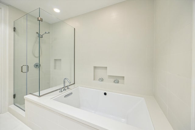 2207 Bancroft St Unit 301, Houston, TX 77027 - bathroom with a stall shower, a garden tub, and recessed lighting
