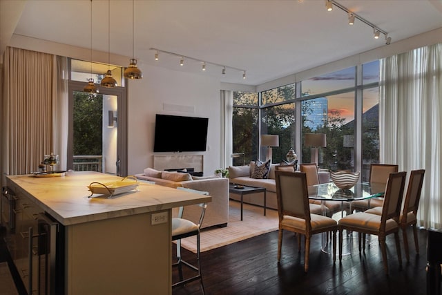 2207 Bancroft St Unit 301, Houston, TX 77027 - dining space with track lighting, dark wood finished floors, and beverage cooler