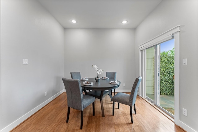 dining room with baseboards, recessed lighting, and wood finished floors