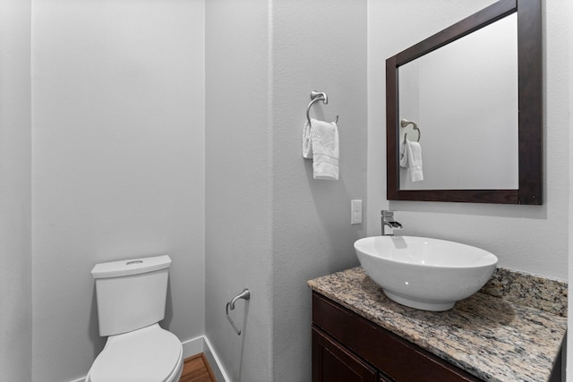 half bath with vanity and toilet