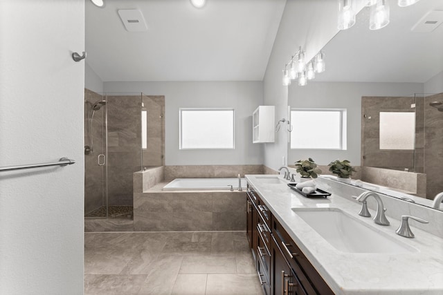 bathroom with a sink, a stall shower, and a healthy amount of sunlight
