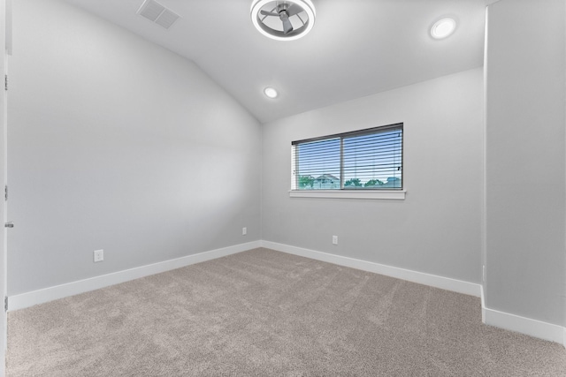 carpeted empty room featuring baseboards, visible vents, recessed lighting, and lofted ceiling