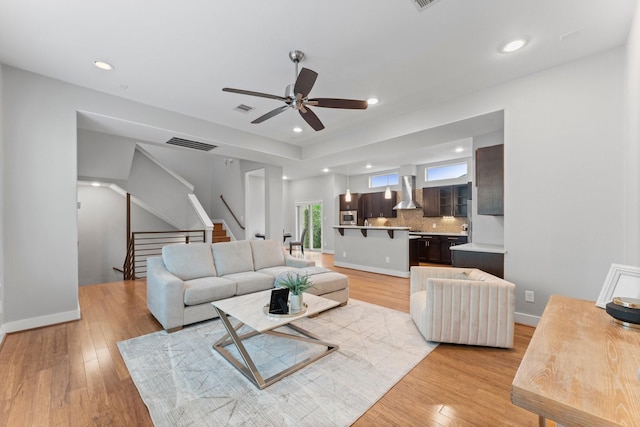 5739 Petty St, Houston, TX 77007 - living room with a ceiling fan, light wood finished floors, stairs, and recessed lighting