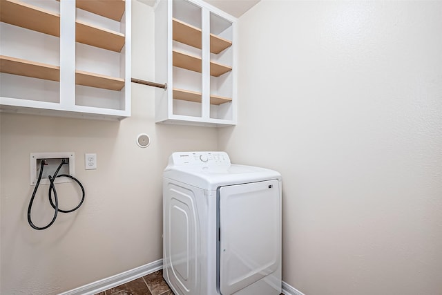 clothes washing area with baseboards, laundry area, and washer / clothes dryer