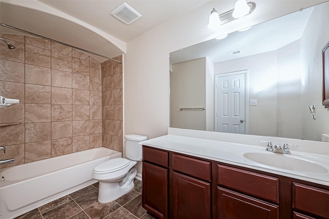bathroom with toilet, visible vents, washtub / shower combination, and vanity