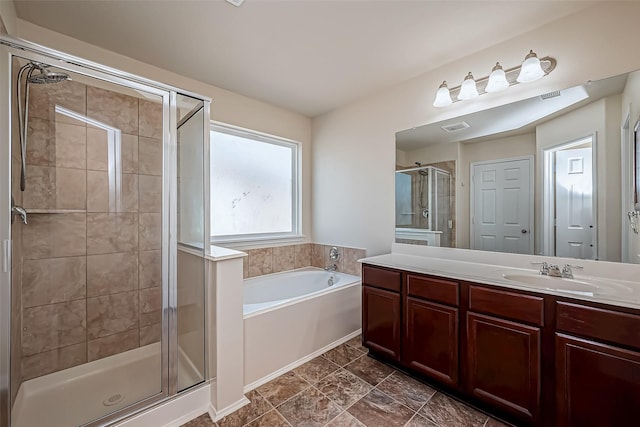 bathroom with a garden tub, vanity, visible vents, and a shower stall