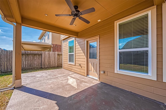 view of patio with ceiling fan and fence