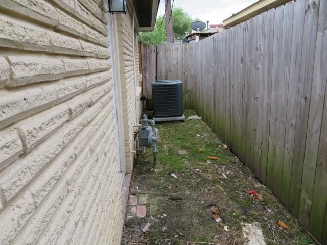 view of home's exterior featuring fence and cooling unit