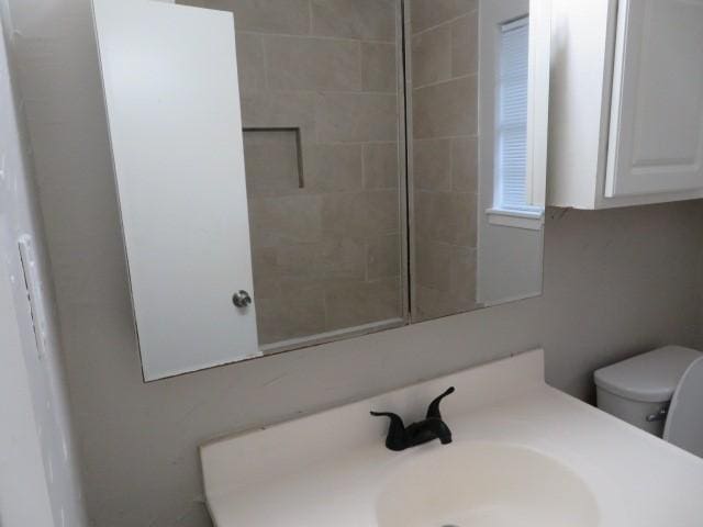 bathroom featuring toilet and vanity