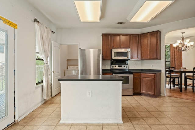 6310 Ringsby Rd, Austin, TX 78747 - kitchen with dark countertops, a chandelier, stainless steel appliances, a wealth of natural light, and visible vents