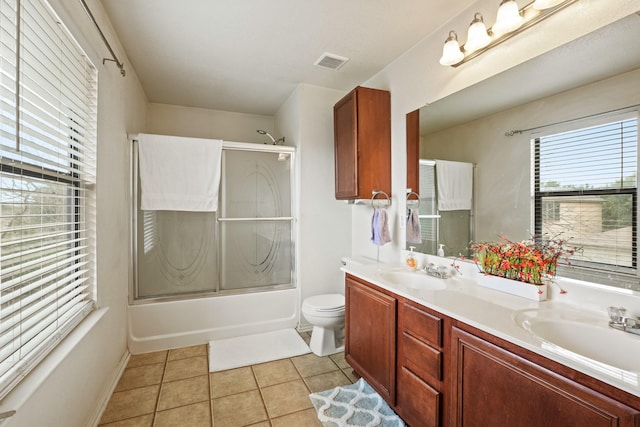 6310 Ringsby Rd, Austin, TX 78747 - full bathroom with double vanity, visible vents, a sink, and shower / bath combination with glass door