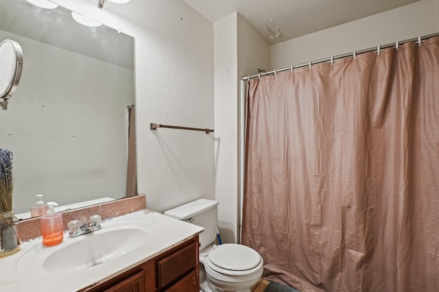 6310 Ringsby Rd, Austin, TX 78747 - bathroom featuring vanity, a textured wall, a shower with curtain, and toilet