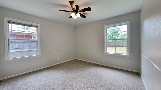 empty room with a ceiling fan, carpet, and baseboards