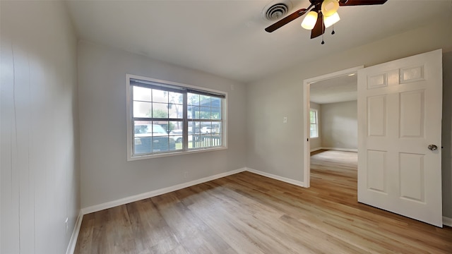 empty room with light wood-style floors, baseboards, and a ceiling fan