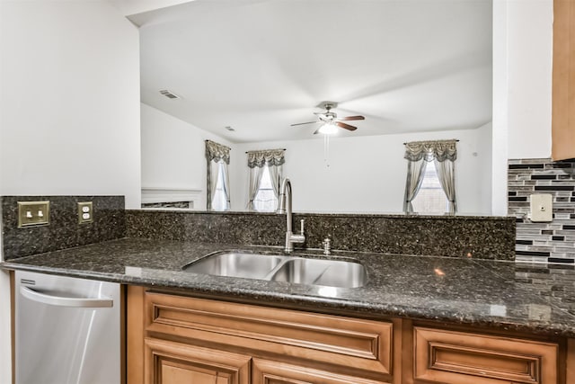kitchen featuring a sink, dishwasher, a ceiling fan, decorative backsplash, and visible vents