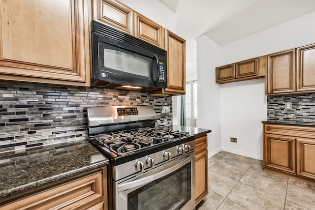 kitchen featuring backsplash, gas range, black microwave, baseboards, and dark stone counters