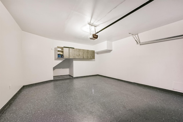 garage with baseboards and a garage door opener