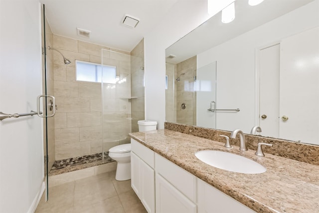 bathroom featuring vanity, toilet, tile patterned floors, and a stall shower