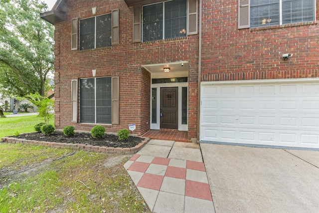 view of front of home featuring a garage, driveway, and brick siding