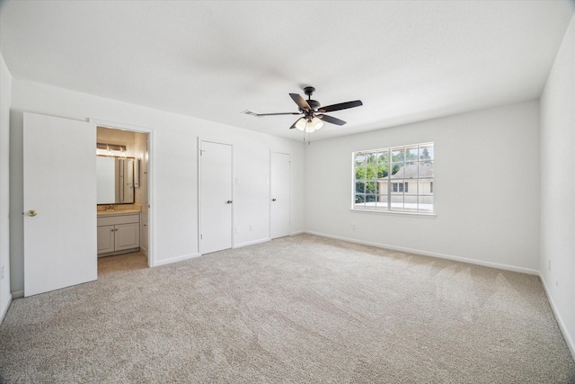 5827 Valley Forge Dr Unit 83, Houston, TX 77057 - unfurnished bedroom featuring light carpet, ensuite bathroom, baseboards, and a sink