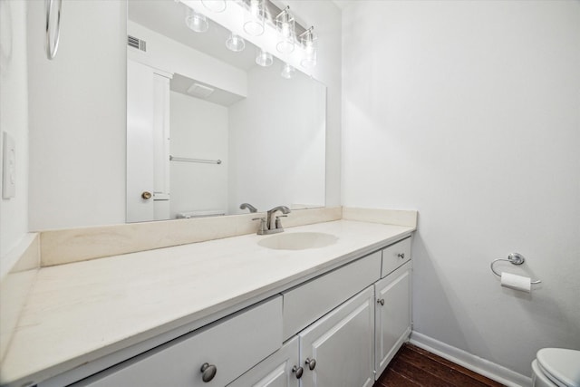 5827 Valley Forge Dr Unit 83, Houston, TX 77057 - bathroom featuring toilet, baseboards, vanity, and wood finished floors